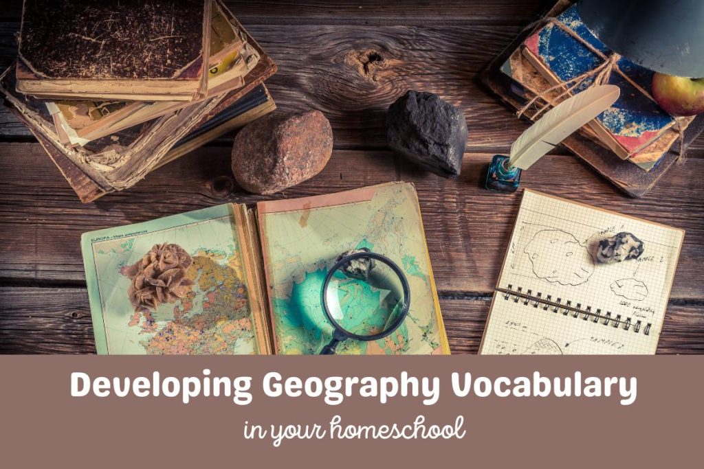 An old desk with rocks, treasures, maps and magnifying glass on. Text below the image reads Developing Geography Vocabulary in your homeschool.