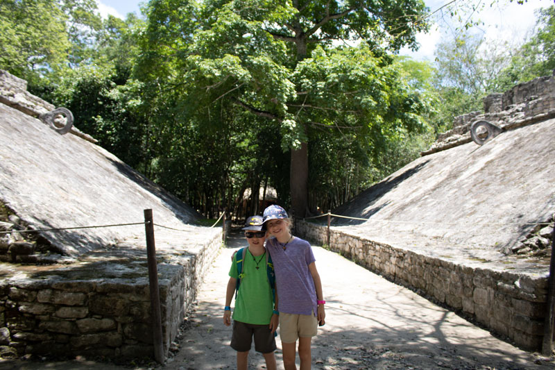 rainy day homeschooling kids in a small pok a tok court at Coba in Mexico.