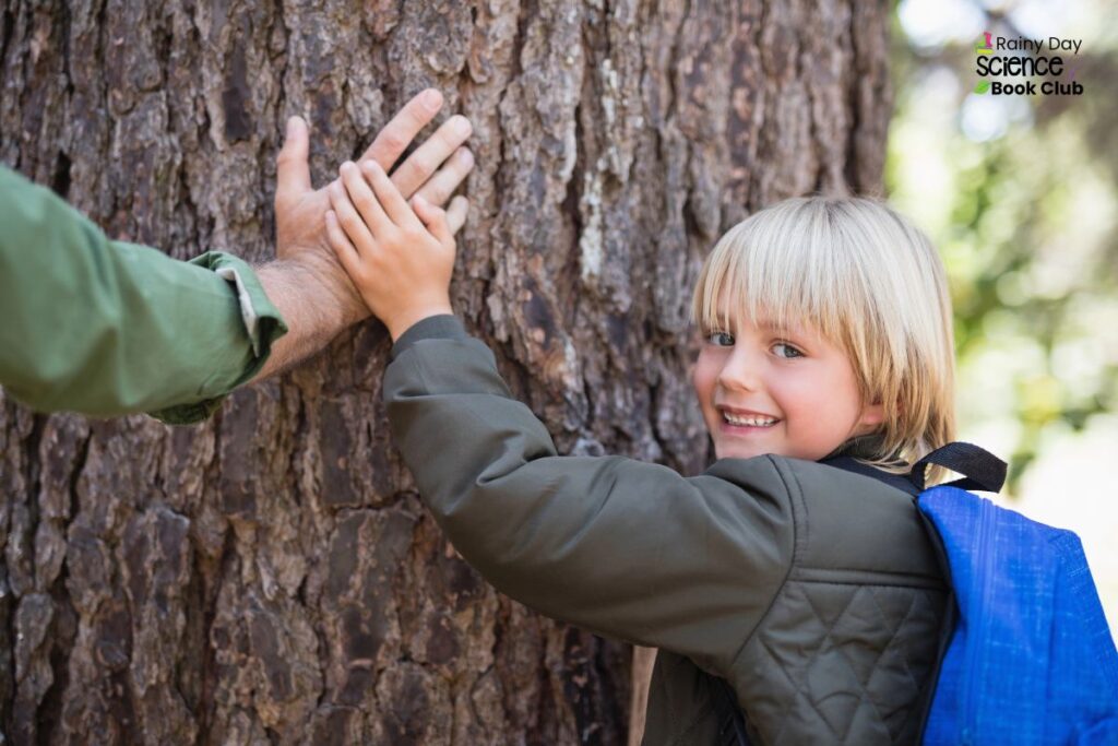 Son and dad looking at trees as part of a nature study activity.